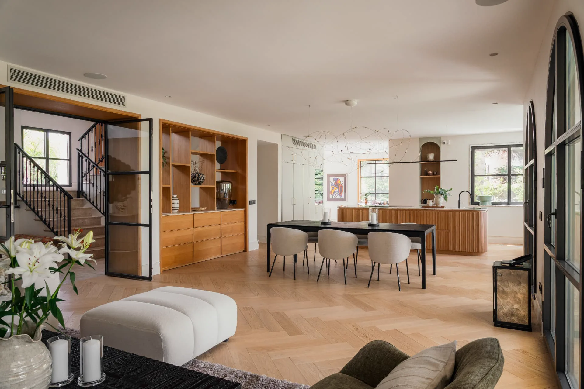 The open living, dining and kitchen space with its oak joinery and sculptural light